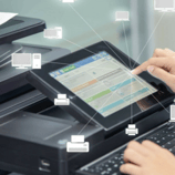 Printer Screen With Hands Touching The Buttons