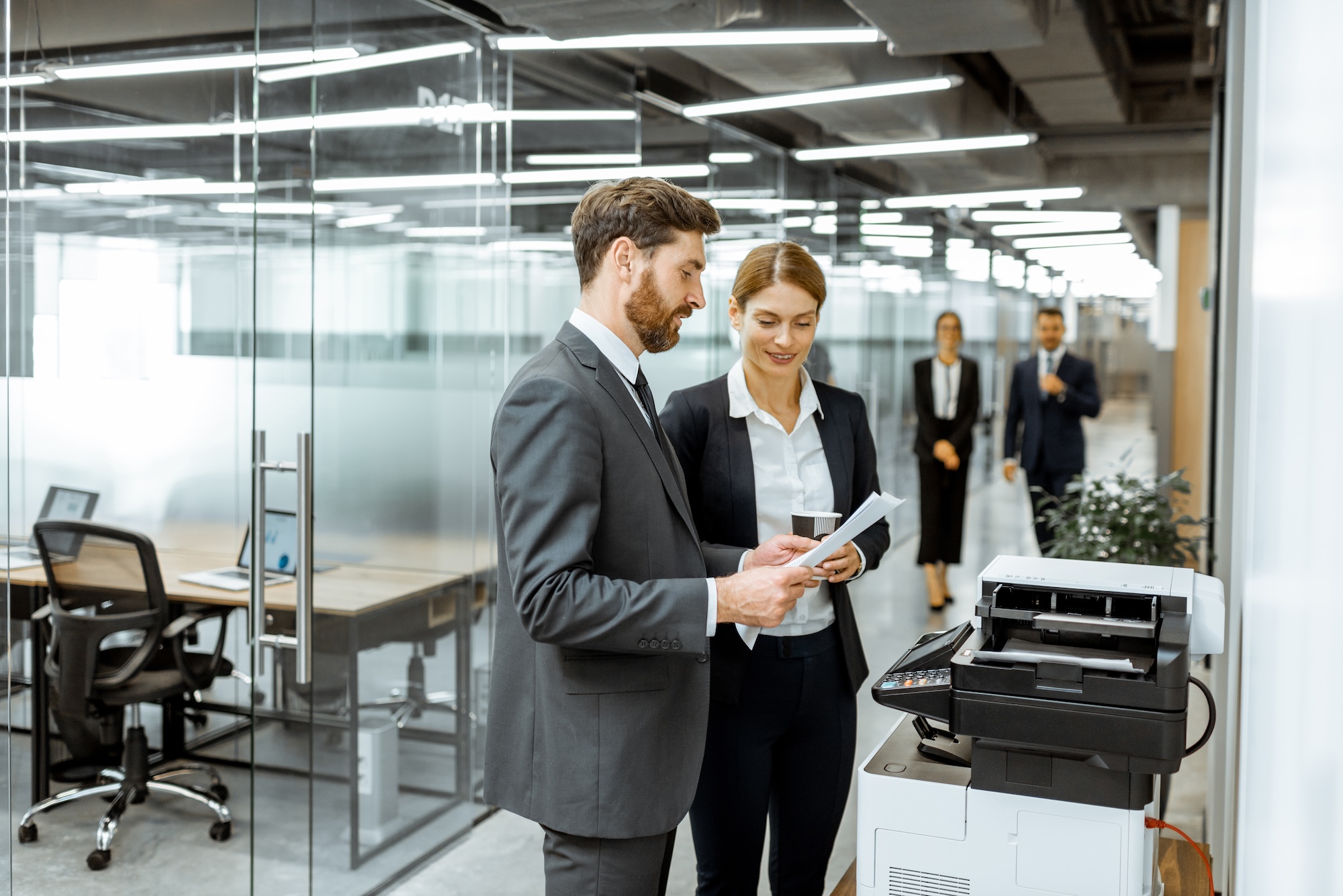 Lawyers using a printer in a corporate office.